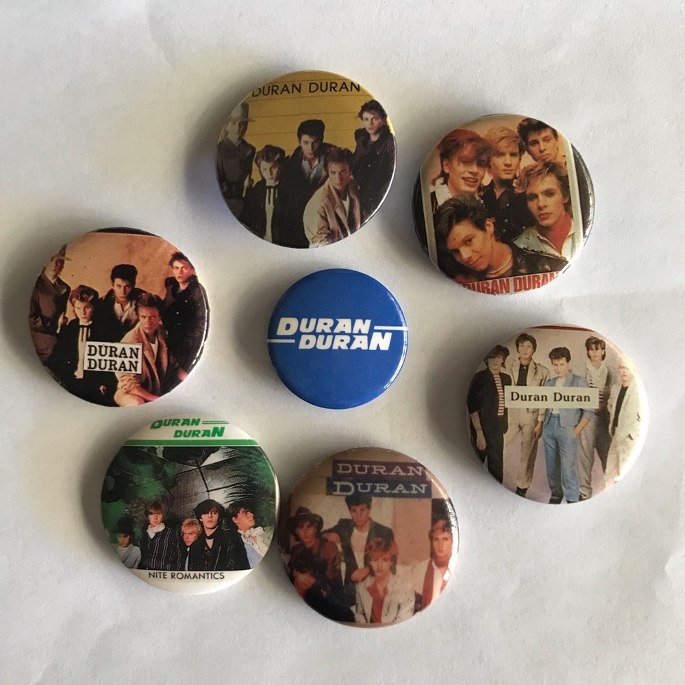 Lot of 7 Vintage 1984 Duran Duran collectible pin back buttons.